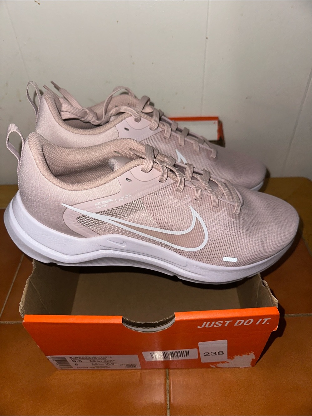Nike Women's Light Pink Running Sneakers with White Swoosh box is damaged